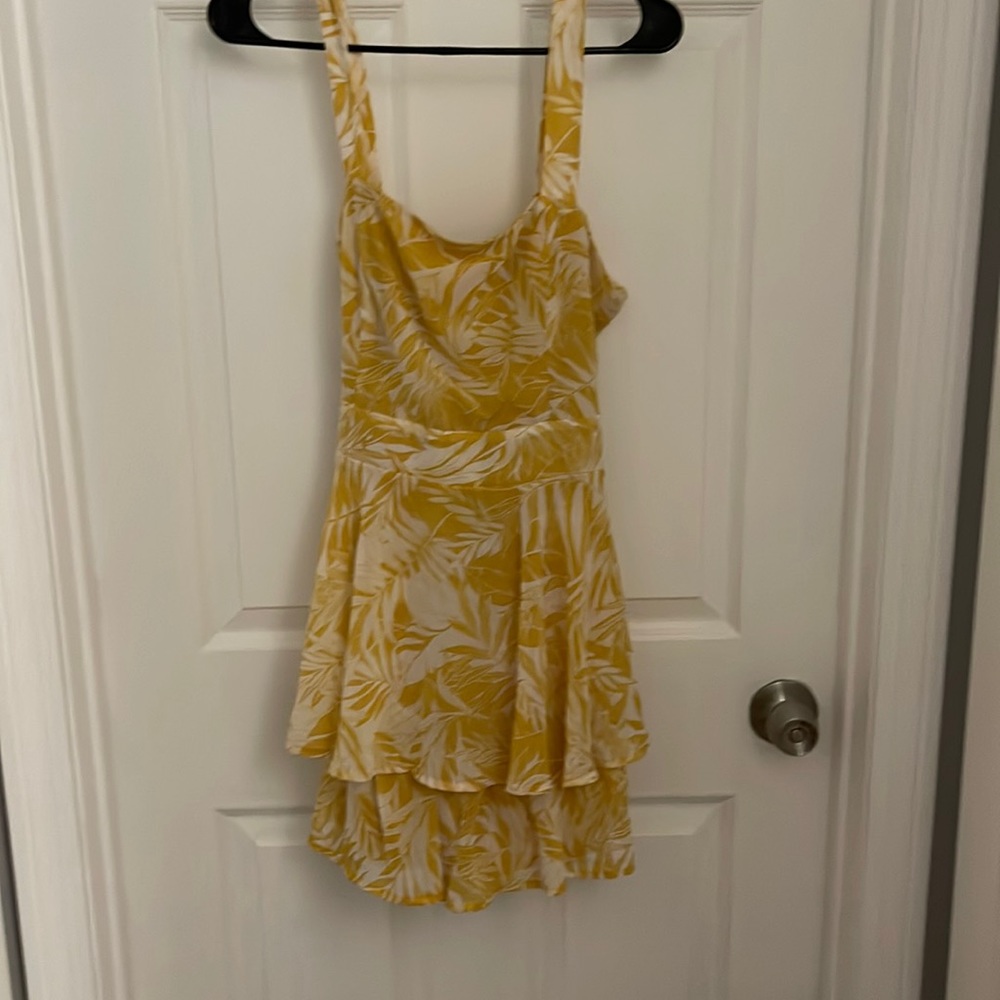 Yellow and white patterned romper new with tags size XL.